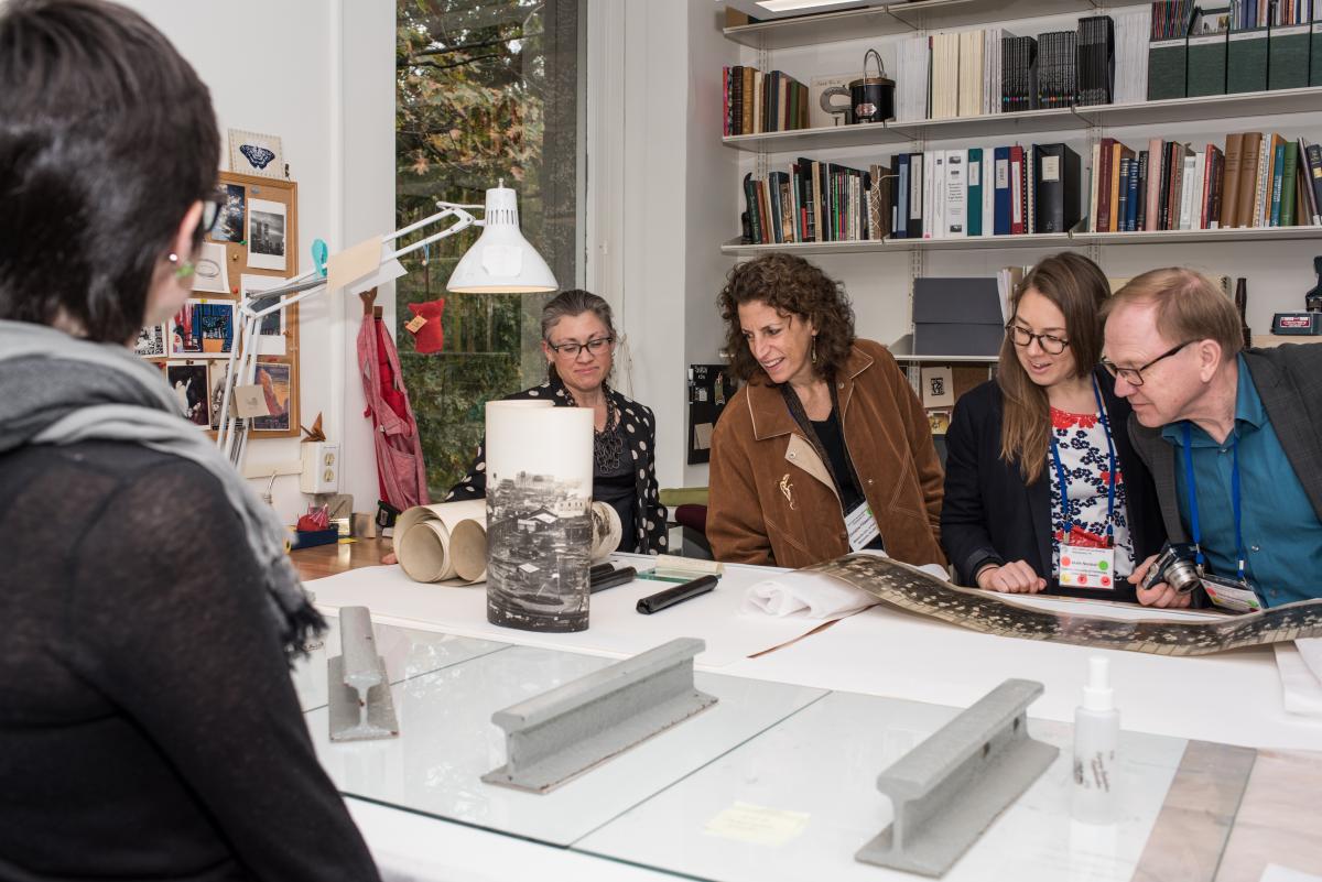 Library conservator Laura Wahl shows the group a panoramic photo being flattened. Photo by Jackie Kane Photography.