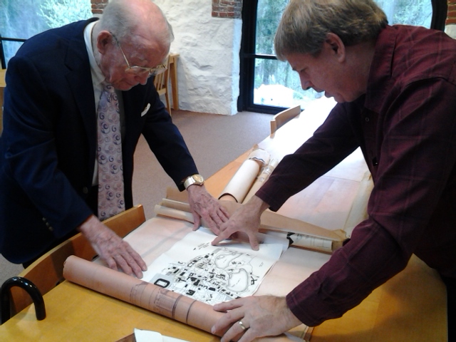 Ken White and his son, Andrew, unrolling one of the plans from the new additions to his collection here at Hagley.